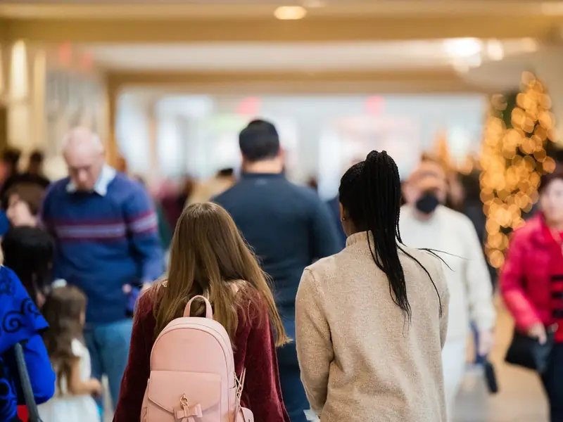 Shoppers walking through a busy shopping centre